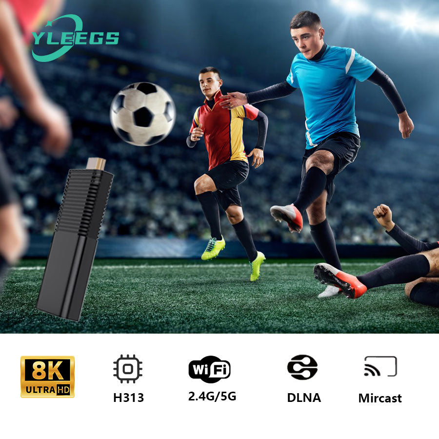 Close-up of the YLEGS I96D1 smart TV stick featuring a sleek black design and HDMI connector, set against a vibrant sports stadium background with children playing soccer, highlighting its 8K Ultra HD support, H313 processor, dual-band WiFi, DLNA, and Miracast for seamless streaming and device connectivity.